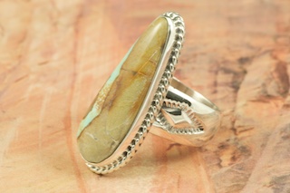 Genuine Boulder Turquoise set in Sterling Silver Ring. The cabachon is Boulder Turquoise, you can see the veins of Turquoise running through the host rock. The Boulder Turquoise Mine is located in northeast Nevada. It was discovered in 1970 by a Shoshone sheep herder. Production is small due to the remote location and winter weather. Boulder Turquoise is valued for both it's beauty and rarity. Every stone is unique. Created by Navajo Artist Tony Garcia. Signed by the artist.
